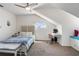 Bright bedroom with a vaulted ceiling, dormer window, and cozy study area, creating a versatile living space at 861 Nectar Rd, Venice, FL 34293