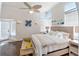 Bright bedroom features a queen bed, wood floors, neutral decor, and ample natural light at 861 Nectar Rd, Venice, FL 34293