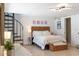 Cozy bedroom with spiral staircase, queen bed, and stylish décor provides a relaxing retreat at 861 Nectar Rd, Venice, FL 34293