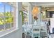 Dining area featuring a chandelier, light blue walls, and a large window for ample natural light at 861 Nectar Rd, Venice, FL 34293