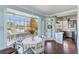 Bright dining area with large windows, stylish light fixture, and an adjoining kitchen at 861 Nectar Rd, Venice, FL 34293