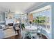 Inviting dining area with large windows, a fireplace, and comfortable seating for Gathering meals at 861 Nectar Rd, Venice, FL 34293