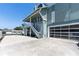 Charming two-story home with a glass panel garage door and staircase leading to the front porch, a captivating facade at 861 Nectar Rd, Venice, FL 34293