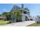 Inviting two-story home with a charming porch, lush landscaping, and a spacious driveway at 861 Nectar Rd, Venice, FL 34293