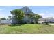 Charming two-story home featuring a lush green lawn and mature tropical landscaping at 861 Nectar Rd, Venice, FL 34293