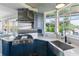 Open kitchen with stainless steel appliances, stylish range hood, and plenty of counter space at 861 Nectar Rd, Venice, FL 34293