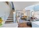 Charming living room featuring stairs, wood floors, blue accents, and a beautiful area rug at 861 Nectar Rd, Venice, FL 34293
