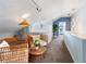 Stylish loft space featuring rattan furniture, soft carpeting, and an open floor plan leading to a well-lit hallway at 861 Nectar Rd, Venice, FL 34293