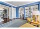 Bright home office with blue walls, built-in shelving, and comfortable seating at 861 Nectar Rd, Venice, FL 34293