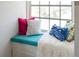 Inviting window seat with colorful pillows and a soft throw blanket, perfect for relaxation at 861 Nectar Rd, Venice, FL 34293