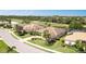 Beautiful aerial view of a home with lush landscaping, pool and proximity to a golf course at 8712 Grey Oaks Ave, Sarasota, FL 34238