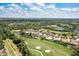 Panoramic aerial view of the house on a lot with beautiful pond and golf course views at 8712 Grey Oaks Ave, Sarasota, FL 34238