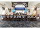Upscale bar area with ample seating, a well-stocked bar, and modern decor creating a luxurious atmosphere at 8712 Grey Oaks Ave, Sarasota, FL 34238