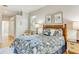 Comfortable bedroom featuring a stylish bed, side tables with lamps, beach themed decor, and a serene color palette at 8712 Grey Oaks Ave, Sarasota, FL 34238