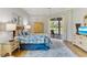 Beautiful bedroom with pool view from lanai doors, complemented by nautical decor and soft, neutral tones at 8712 Grey Oaks Ave, Sarasota, FL 34238
