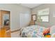 Cozy bedroom with a beach-themed comforter, chair and a view through the window at 8712 Grey Oaks Ave, Sarasota, FL 34238