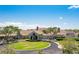 An aerial view showcasing the elegant clubhouse with lush greenery and a circular driveway at 8712 Grey Oaks Ave, Sarasota, FL 34238