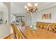 Open-concept dining room with stylish furniture and view to the living room with access to screened lanai at 8712 Grey Oaks Ave, Sarasota, FL 34238