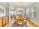 Elegant dining room featuring hardwood floors, a large mirror, and a chandelier at 8712 Grey Oaks Ave, Sarasota, FL 34238