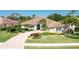 Charming house boasting an elegant circular driveway and lush landscaping at 8712 Grey Oaks Ave, Sarasota, FL 34238