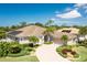 Stunning single-story home featuring a paver driveway, meticulously landscaped yard, and well-maintained tile roof at 8712 Grey Oaks Ave, Sarasota, FL 34238