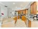 The kitchen features light tile floors, stainless steel appliances, and granite countertops at 8712 Grey Oaks Ave, Sarasota, FL 34238