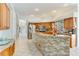 Bright kitchen boasting a stone-accented breakfast bar and stainless steel appliances at 8712 Grey Oaks Ave, Sarasota, FL 34238