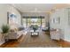 Bright living room featuring hardwood floors, a ceiling fan, and seamless flow to the lanai at 8712 Grey Oaks Ave, Sarasota, FL 34238