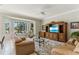 Spacious living room with ceiling fan, large windows and comfortable seating at 8712 Grey Oaks Ave, Sarasota, FL 34238