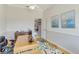 Bright home office featuring a wood desk, neutral walls with white trim, and stylish nautical-themed wall art at 8712 Grey Oaks Ave, Sarasota, FL 34238