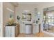Outdoor kitchen with stone countertops, stainless steel mini-fridge and beach-themed decor at 8712 Grey Oaks Ave, Sarasota, FL 34238