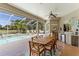 Spacious screened patio with a dining table and an outdoor kitchen overlooking the pool at 8712 Grey Oaks Ave, Sarasota, FL 34238