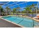 Screened-in pool with palm trees and golf course views providing a private outdoor oasis at 8712 Grey Oaks Ave, Sarasota, FL 34238