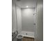 Bathroom featuring a walk in shower with white subway tiles and a pebble tile floor at 8810 1/2 N Mulberry St, Tampa, FL 33604