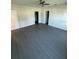 Spacious bedroom featuring modern gray flooring, a ceiling fan, and ample closet space at 8810 1/2 N Mulberry St, Tampa, FL 33604