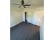 Bedroom featuring wood-look floors, ceiling fan, and closet with white doors for ample storage space at 8810 1/2 N Mulberry St, Tampa, FL 33604