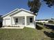Charming single-story home featuring a well-manicured lawn, attached garage, and a freshly painted exterior at 8810 1/2 N Mulberry St, Tampa, FL 33604