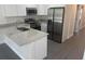 Stylish kitchen with stainless steel appliances, granite countertops, white cabinetry, and a breakfast bar at 8810 1/2 N Mulberry St, Tampa, FL 33604
