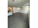 Expansive living room with modern gray flooring, neutral walls, and a ceiling fan at 8810 1/2 N Mulberry St, Tampa, FL 33604