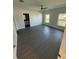 Bright bedroom with a ceiling fan, two windows, and dark floors at 8810 N Mulberry St, Tampa, FL 33604
