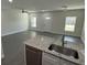 Open-concept living room with granite countertop, stainless steel appliances, and ample natural light at 8810 N Mulberry St, Tampa, FL 33604