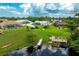 Aerial view of the backyard, dock, and pond at 11895 Claremont Dr, Port Charlotte, FL 33981