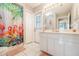 Bathroom featuring a vanity, toilet, shower, and door to the patio with bright decor throughout at 11895 Claremont Dr, Port Charlotte, FL 33981