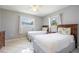 Neutral bedroom with tile flooring, ceiling fan, and two twin beds with matching night stands at 11895 Claremont Dr, Port Charlotte, FL 33981