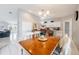 Dining area adjacent to kitchen with island and white cabinets at 11895 Claremont Dr, Port Charlotte, FL 33981