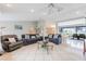 Spacious living room with open concept design, tile flooring, and access to the dining and outdoor areas at 11895 Claremont Dr, Port Charlotte, FL 33981