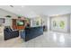 Bright living room with vaulted ceilings, neutral walls, tile flooring, and white doors leading to other rooms at 11895 Claremont Dr, Port Charlotte, FL 33981
