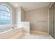 Spacious bathroom featuring a soaking tub and a separate shower at 11895 Claremont Dr, Port Charlotte, FL 33981