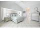 Spacious main bedroom features tile flooring and ensuite bathroom at 11895 Claremont Dr, Port Charlotte, FL 33981