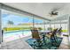 Enclosed patio featuring a dining table, ceiling fan, and views of the pool and landscaped backyard at 11895 Claremont Dr, Port Charlotte, FL 33981